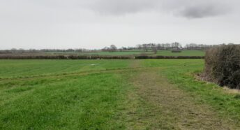 Open countryside on the Wirral with fields, hedges and a footpath